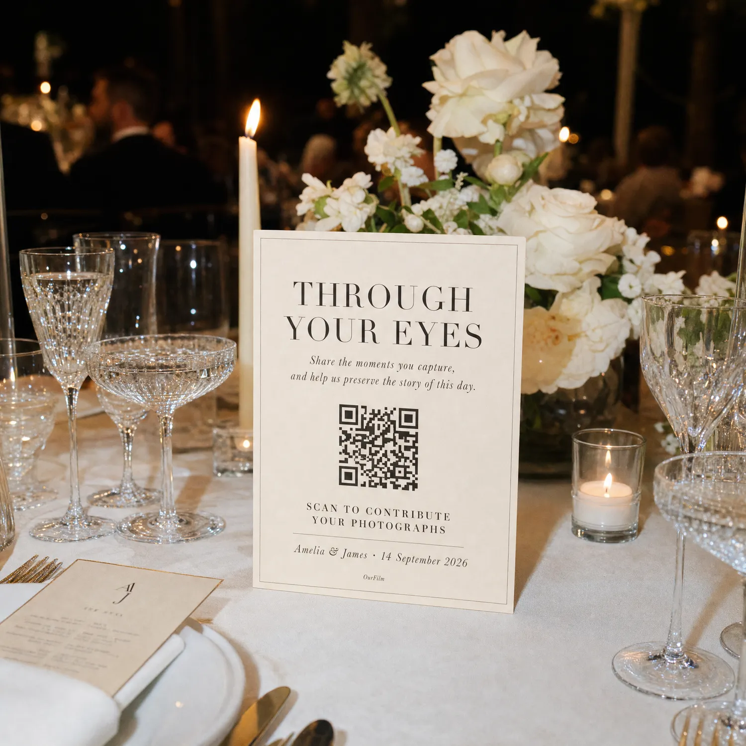 An OurFilm QR card standing on a wedding table